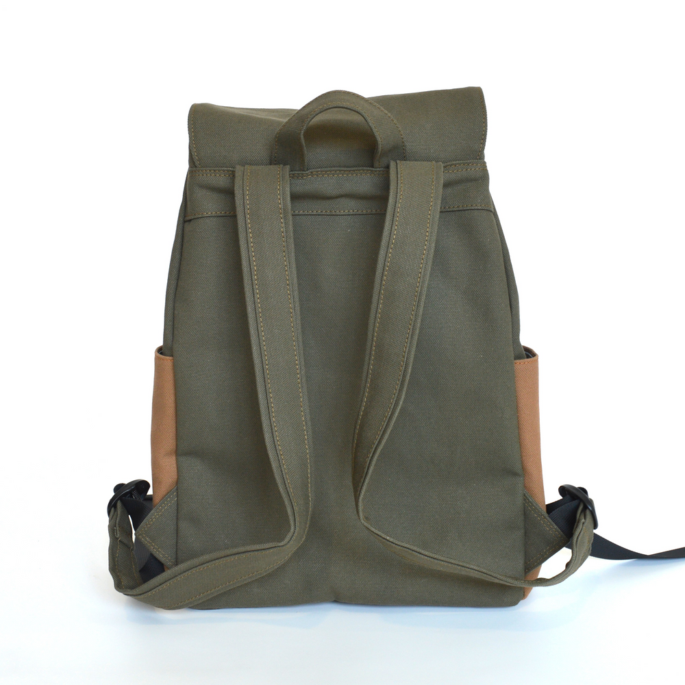 Green backpack with brown leather patches on a white background