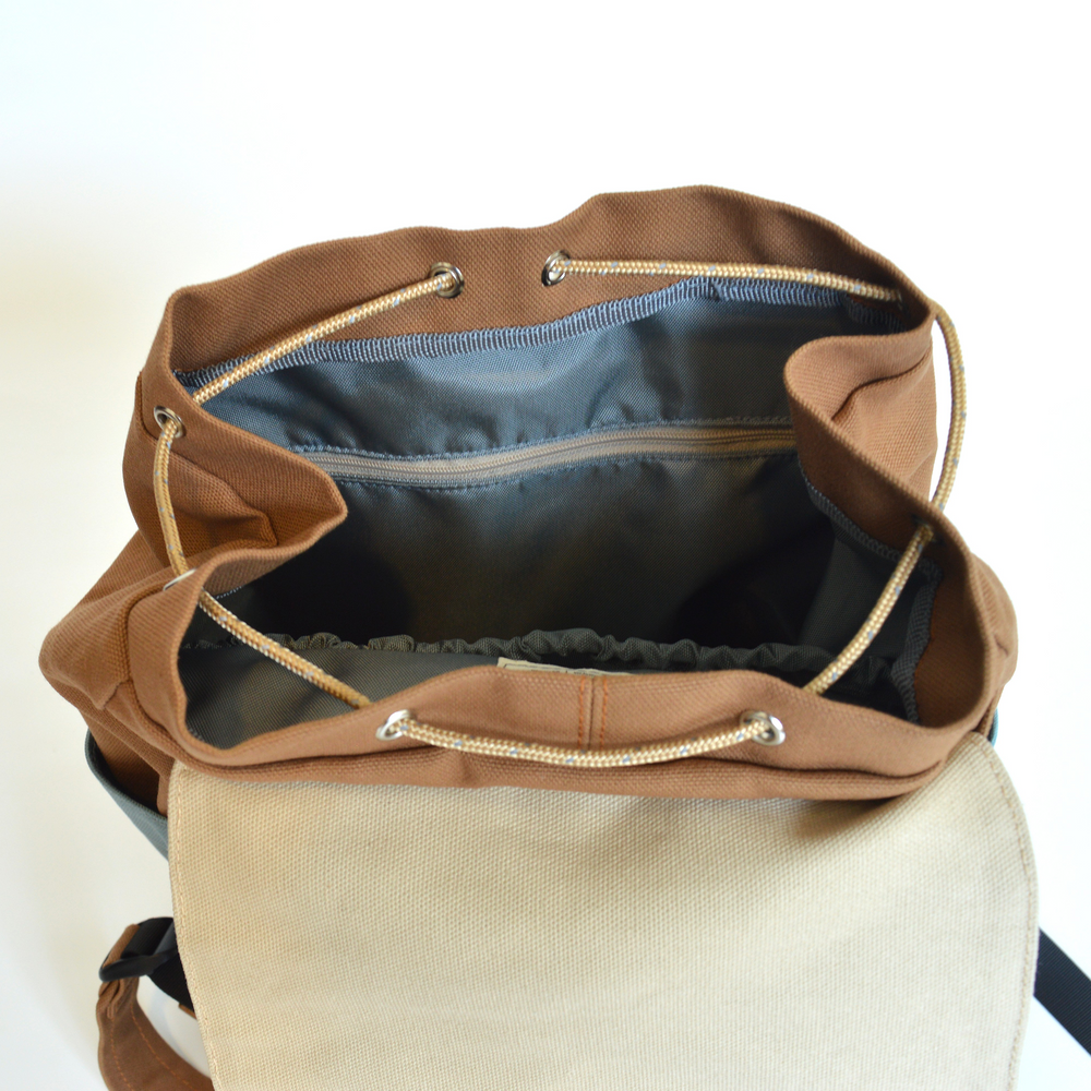 Brown drawstring bag with open top on a white background