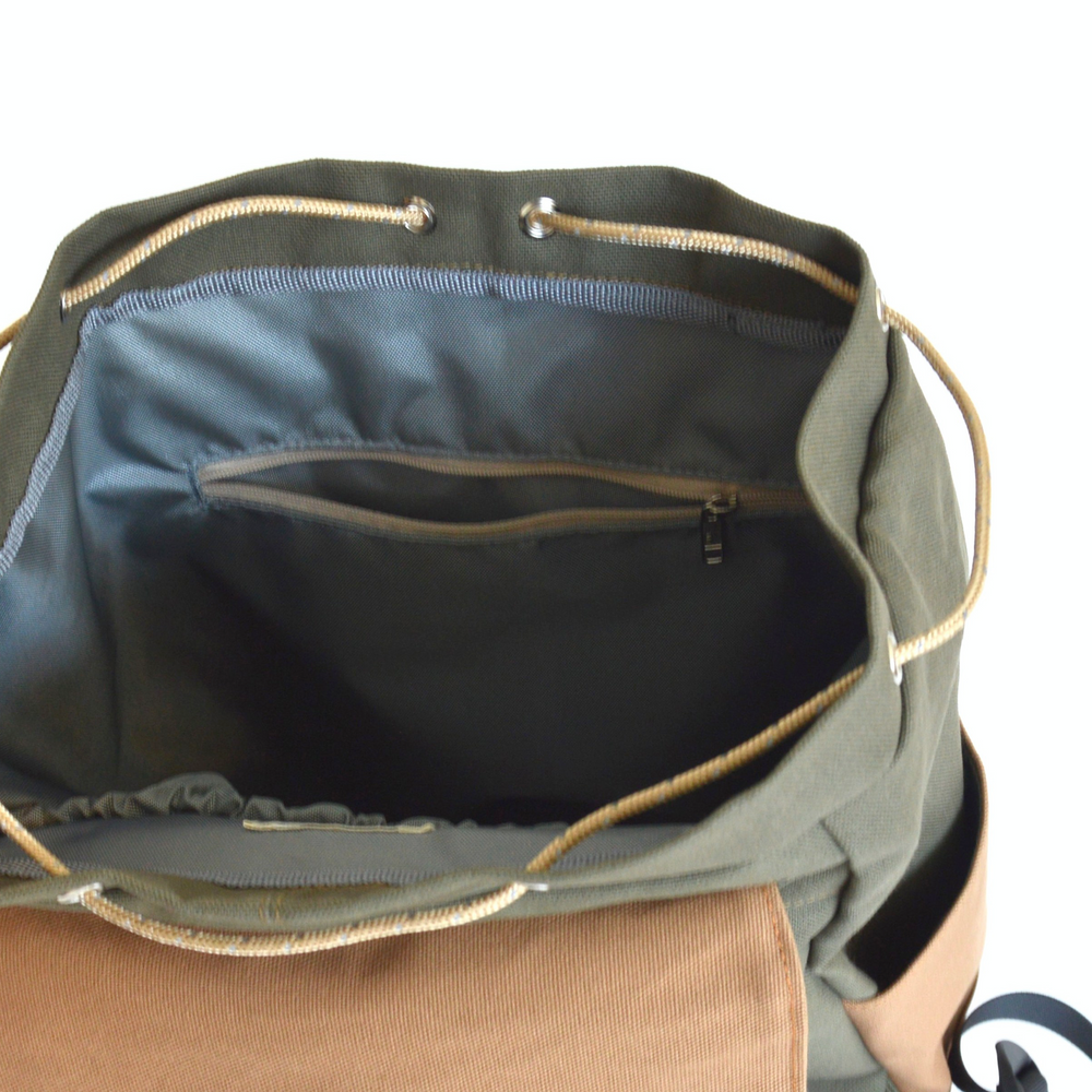 Open green bag with brown interior on a white background