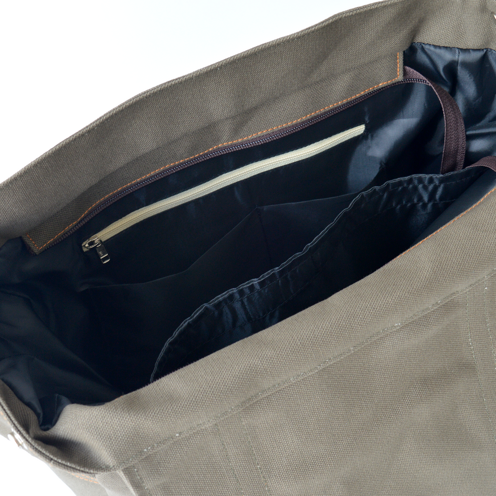 Gray bag with a zipper open, showing a dark interior.
