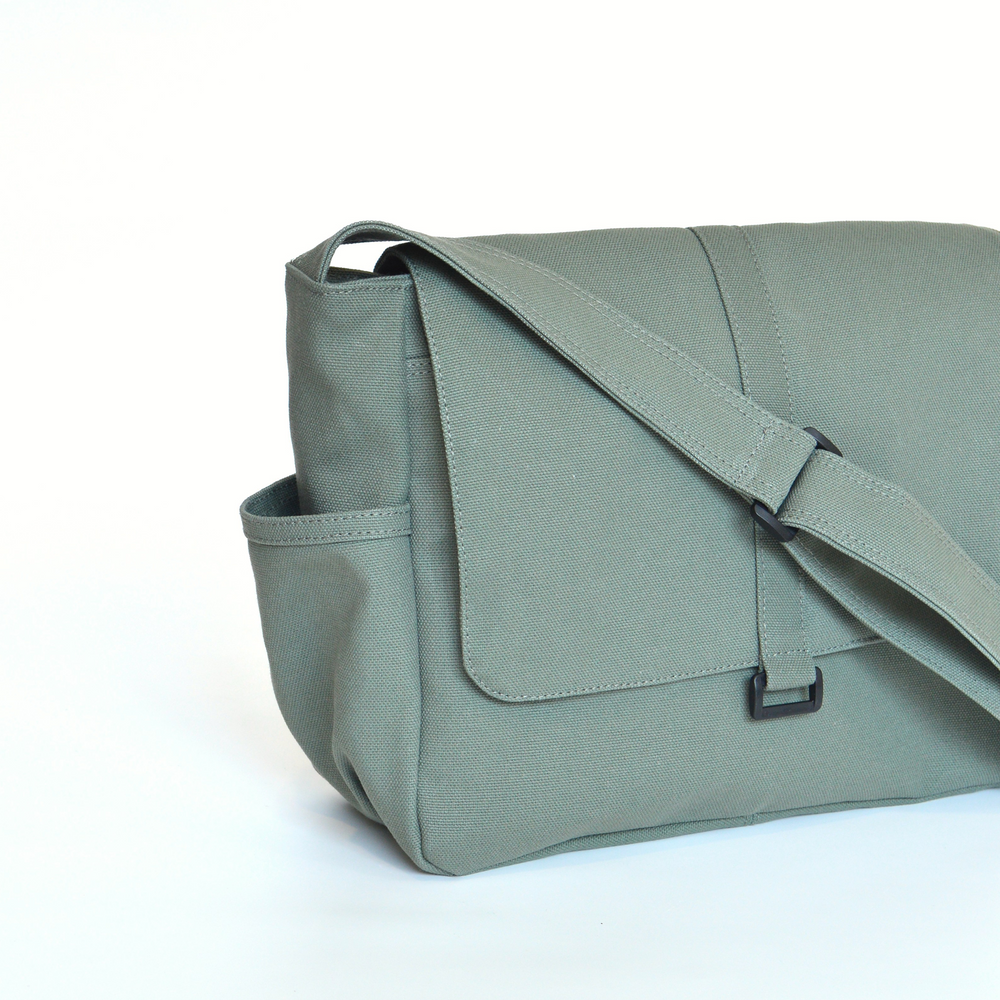 Green shoulder bag on a white background close up.