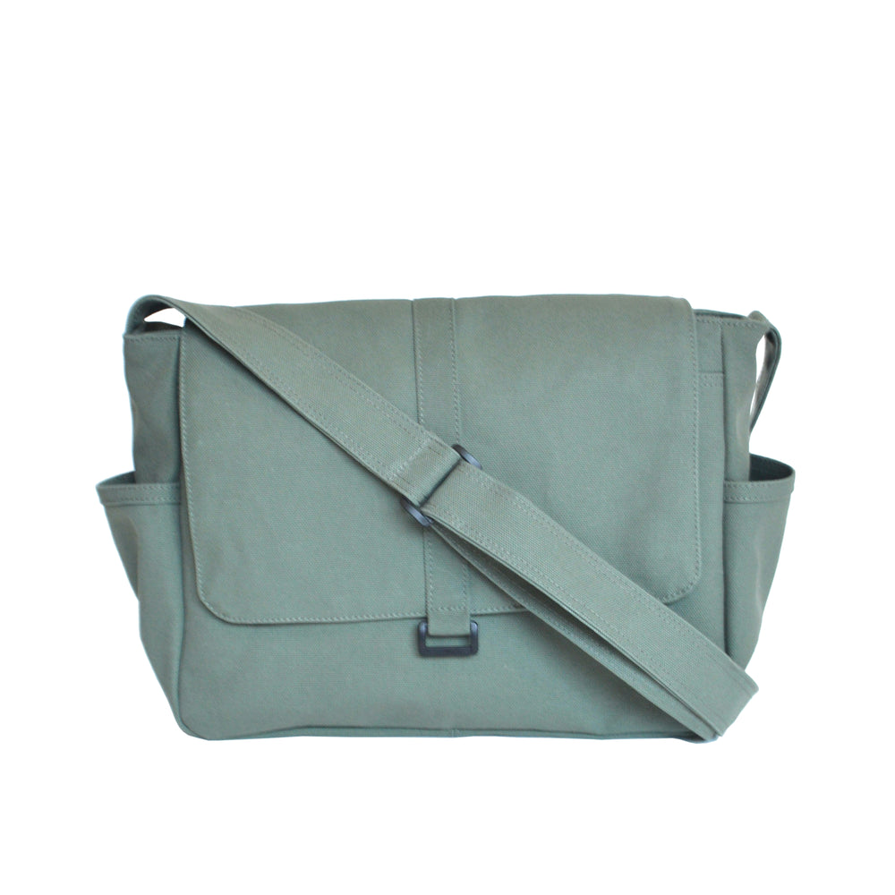Green messenger bag with a strap on a white background