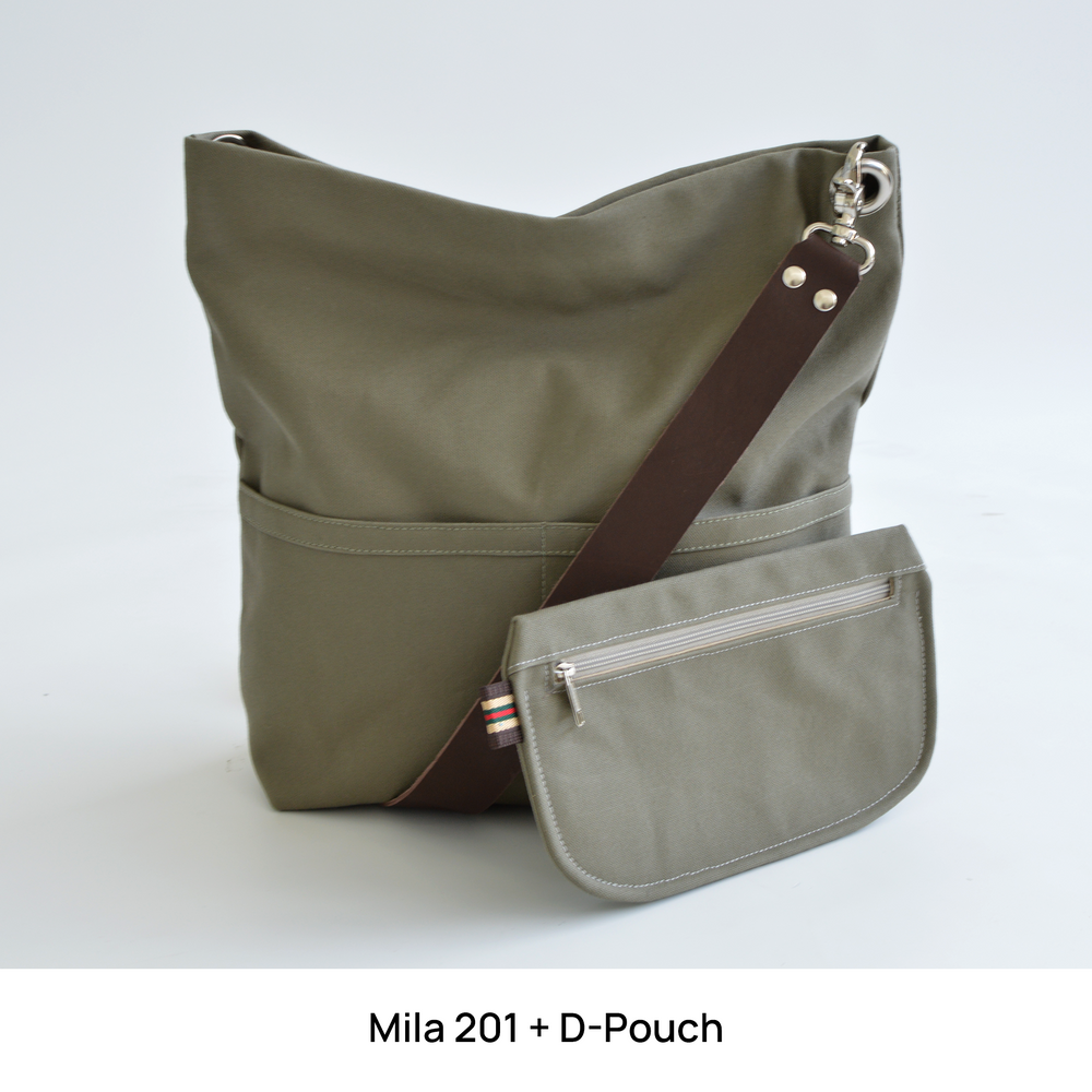 Green shoulder bag with a matching pouch against plain background.