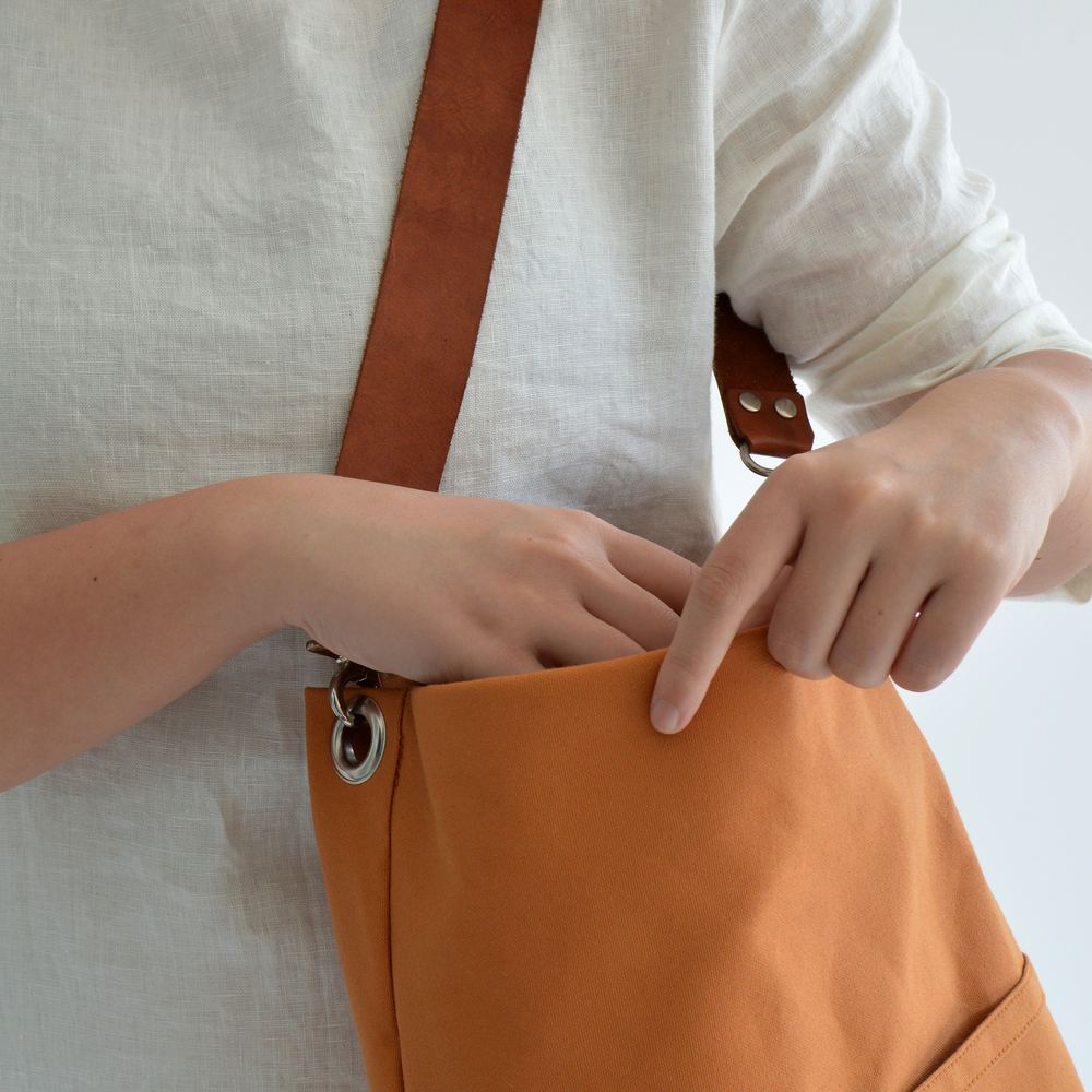 Person holding a brown bag with a white background