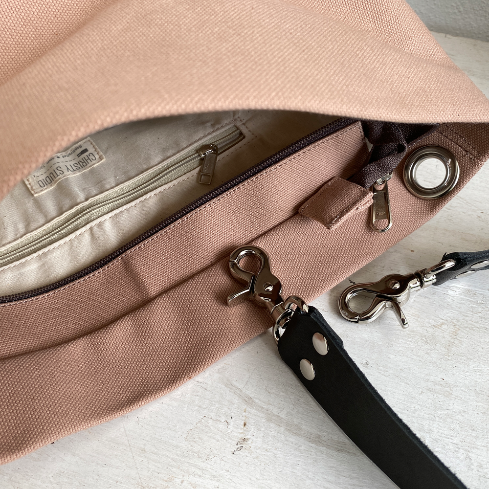 Close up of zipper opening of a light brown bag