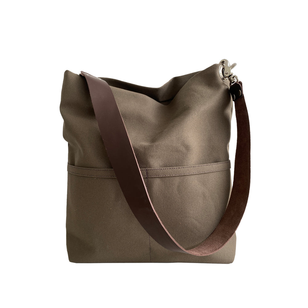 Dark brown shoulder bag with a brown strap on a white background